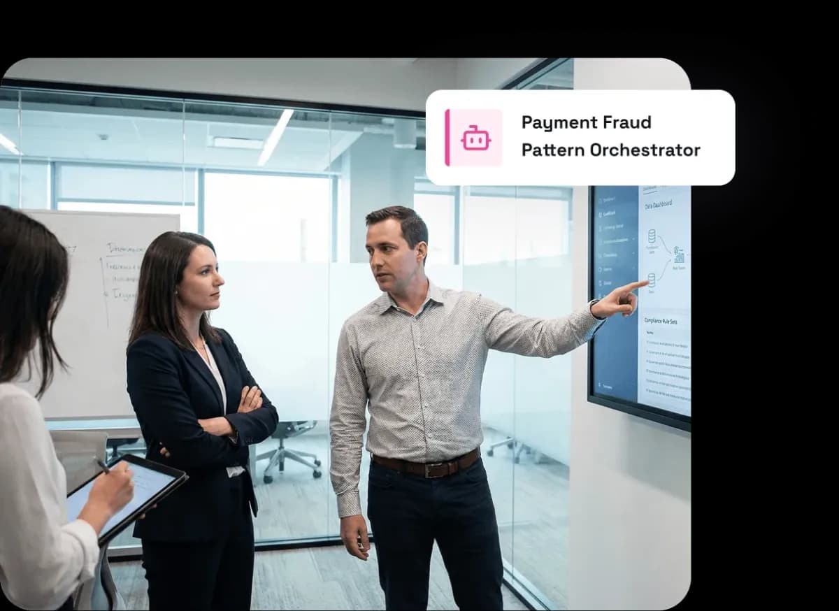 Man presenting data on a screen to two attentive colleagues in a modern office meeting room.